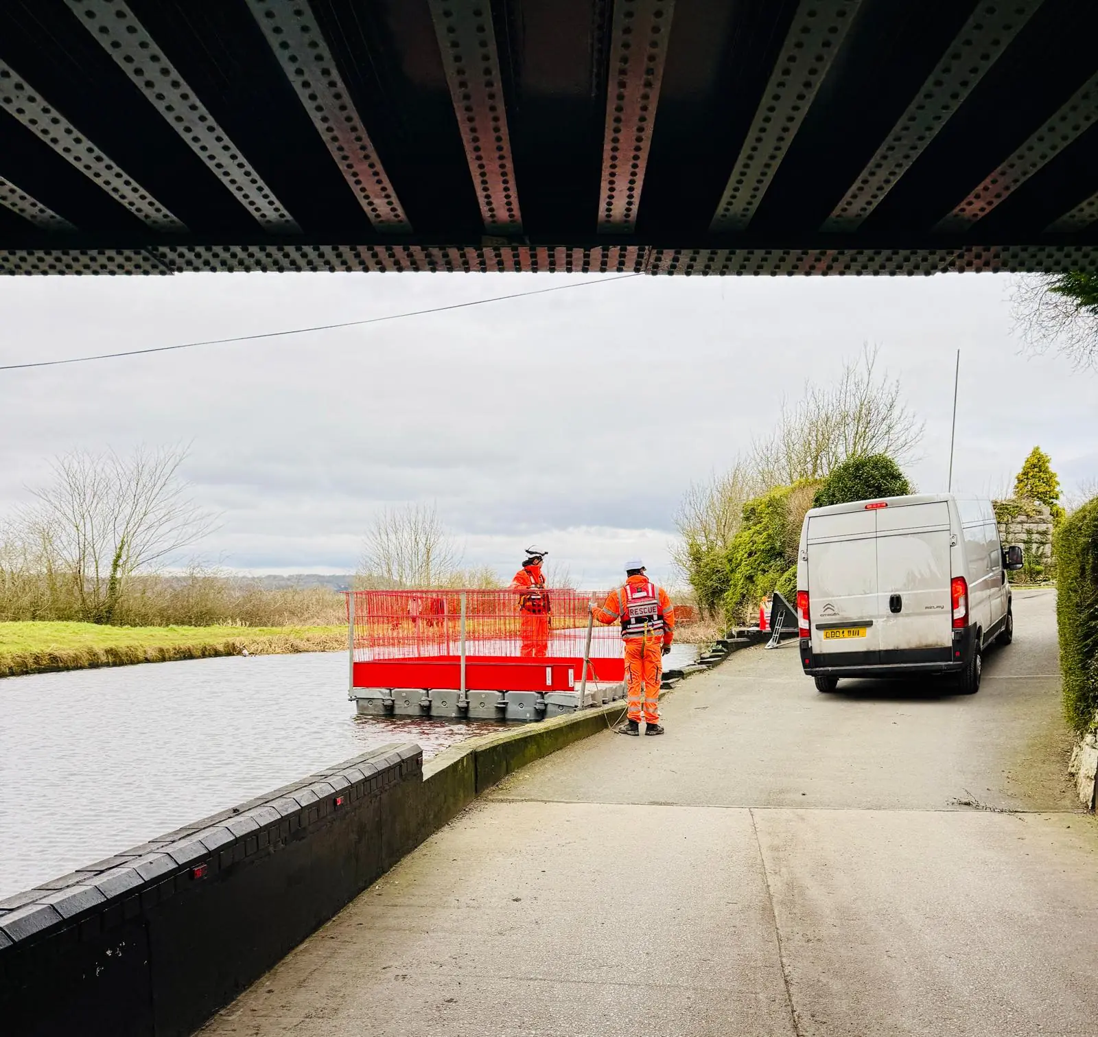 CRM operatives mobilising protected floating access beneath a canal bridge