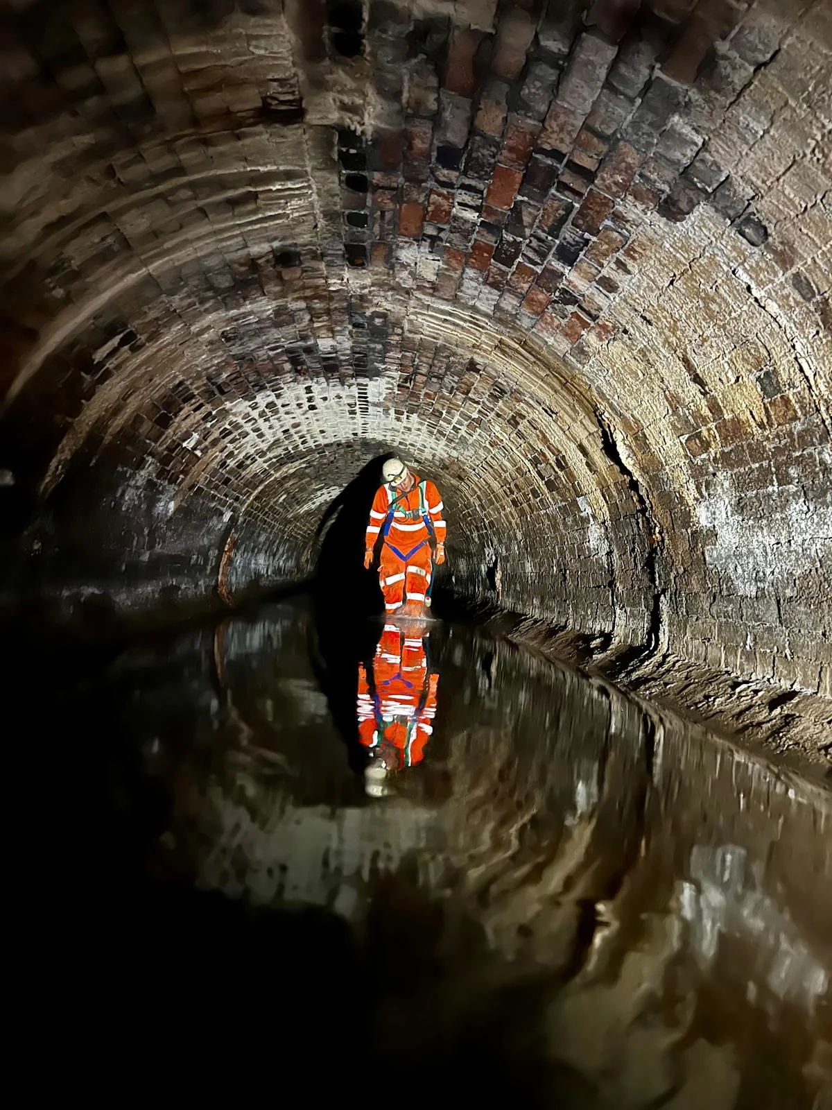 Operative inside a circular culvert during inspection works