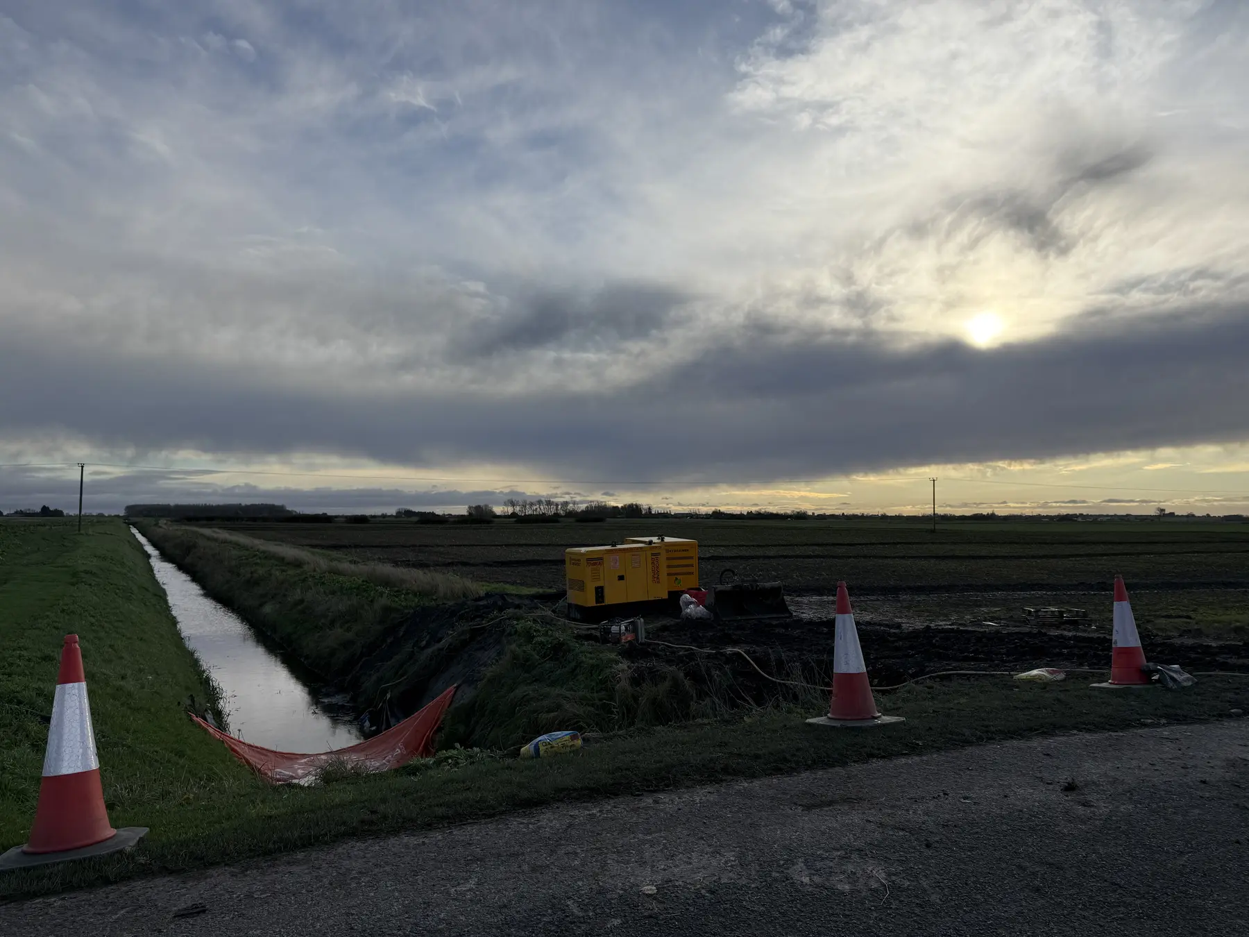 Pumping and water-management equipment operating beside a rural watercourse